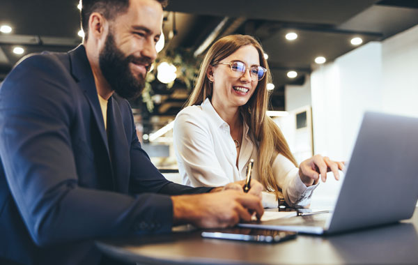 Women referring a service to a friend on a laptop